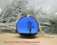 An acrylic painting of a starry night with tree and bird silhouettes on a wood slice at covecreekphotography.com.