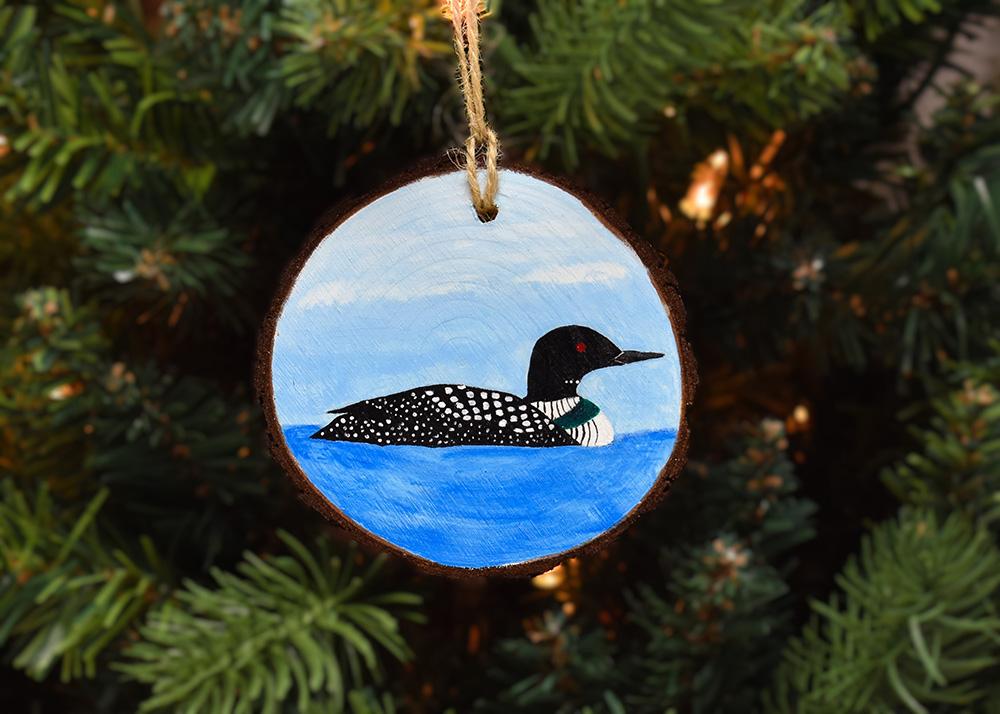 A hand-painted common loon on a wood slice ornament available at www.covecreekphotography.com.