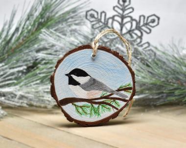 The state bird of Maine, the chickadee, is hand-painted on a three inch wood slice Christmas ornament at covecreekphotography.com.