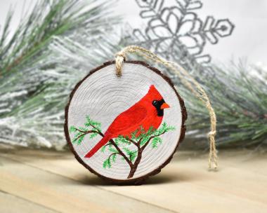 An acrylic painting of a male northern cardinal on a three inch wood slice at covecreekphotography.com.
