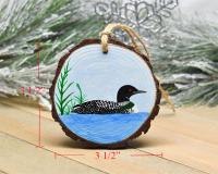 An image of a hand-painted common loon wood slice ornament displaying the three inch diameter measurements at Cove Creek Photography.