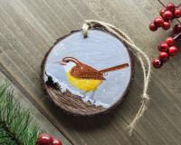 A Carolina wren on a snow covered log hand-painted on a 3 inch wood slice Christmas ornament at covecreekphotography.com. 