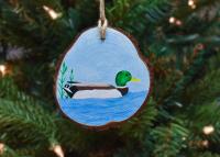 A handmade mallard Christmas ornament hanging on a Christmas tree at covecreekphotography.com/.