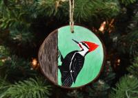 A handmade wood slice ornament with a pileated woodpecker available for purchase at www.covecreekphotography.com.