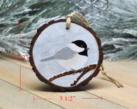 A handmade chickadee Christmas ornament with measurements displayed on each side at Cove Creek Photography.