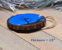 An image showing the thickness of a handmade wood slice Christmas ornament at Cove Creek Photography.