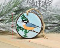 A wood slice Christmas ornament with a hand-painted bird and measurements of the ornament at Cove Creek Photography.
