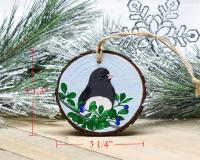 A hand-painted dark-eyed junco Christmas ornament with wood slice measurements at Cove Creek Photography.