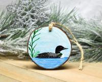 A hand-painted common loon on a wood slice at covecreekphotography.com.