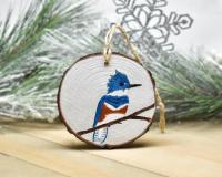 An acrylic painting of a female belted kingfisher on a wood slice Christmas ornament at covecreekphotography.com.