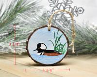 A hooded merganser wood slice houseplant ornament displayed with measurements at covecreekphotography.com.