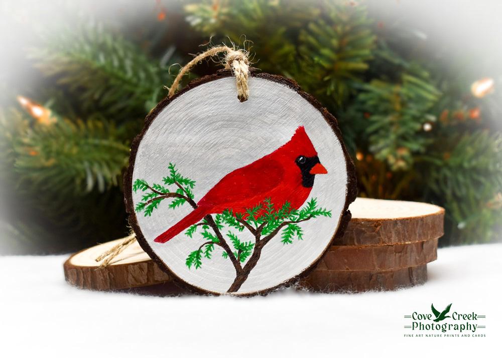 An acrylic painting of a northern cardinal on a wood slice that is available for purchase at covecreekphotography.com.
