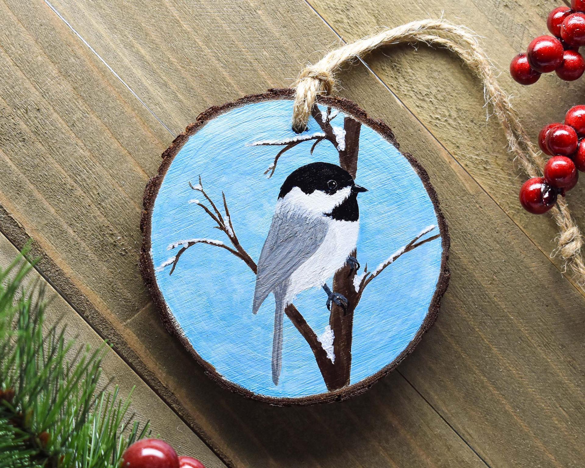A handmade Christmas ornament with a hand-painted Carolina chickadee at covecreekphotography.com.