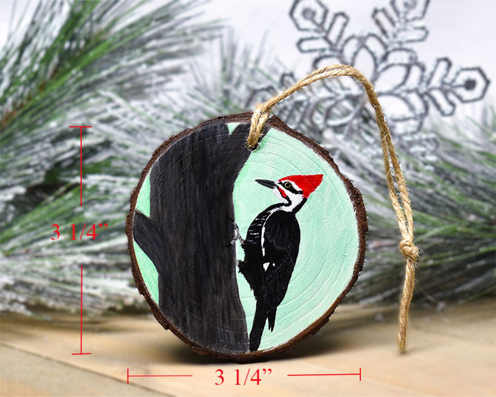 A handmade wood slice Christmas ornament with a pileated woodpecker and wood slice measurements at covecreekphotography.com.