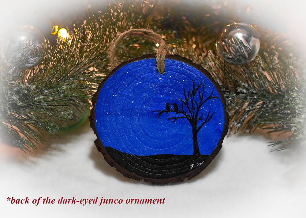 A hand-painted starry night with silhouettes of a tree and birds on a wood slice ornament at covecreekphotography.com.