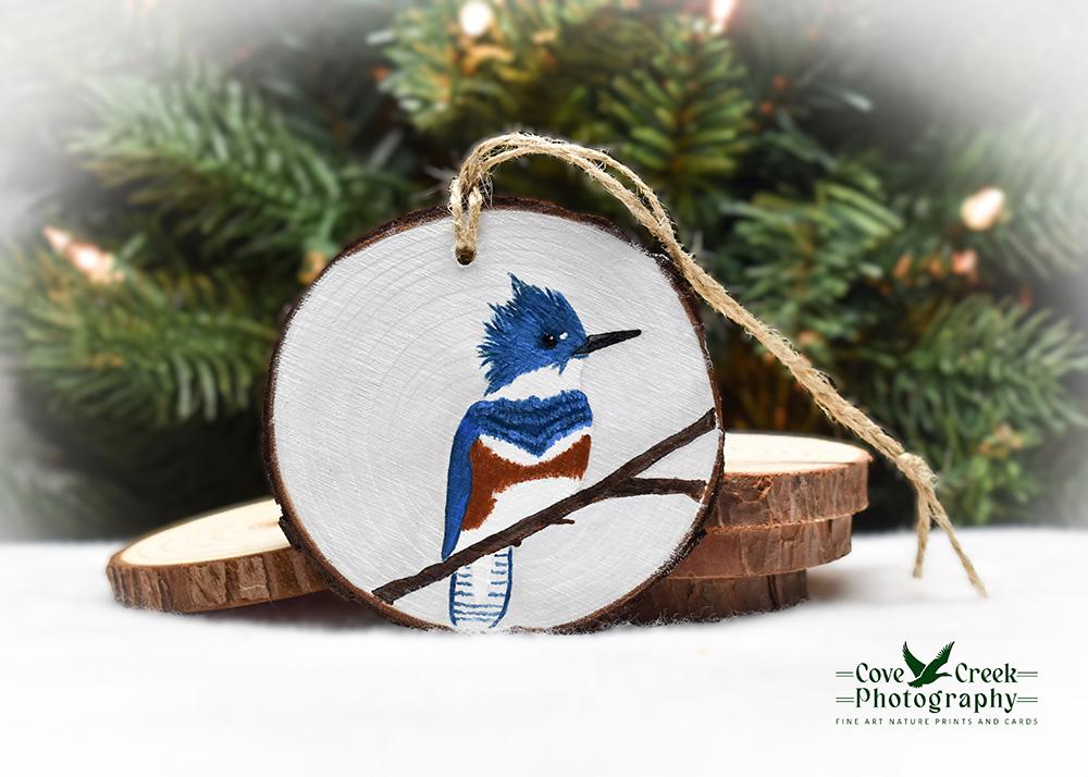 A handmade wood slice ornament with a female belted kingfisher available at www.covecreekphotography.com.