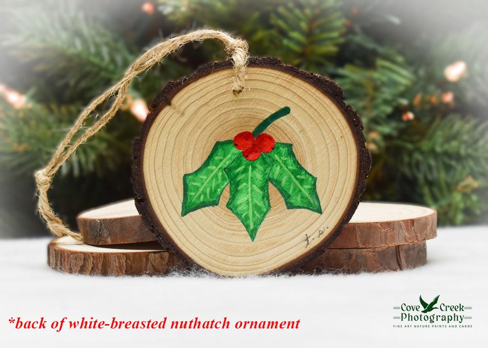 Hand-painted holly leaves and red berries on the back of a nuthatch wood slice ornament at covecreekphotography.com.