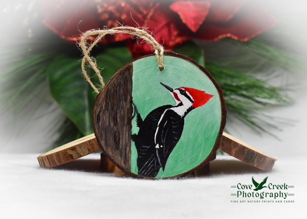A hand-painted pileated woodpecker on a three inch diameter wood slice available at Cove Creek Photography.