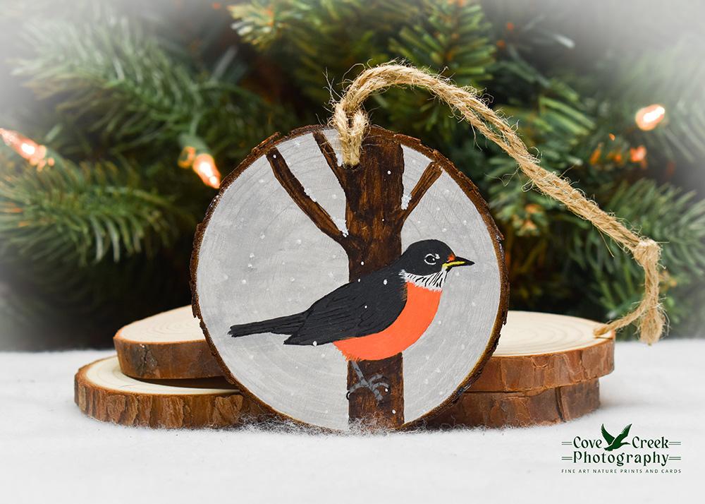 A rustic wood slice Christmas ornament with a hand-painted robin at covecreekphotography.com.