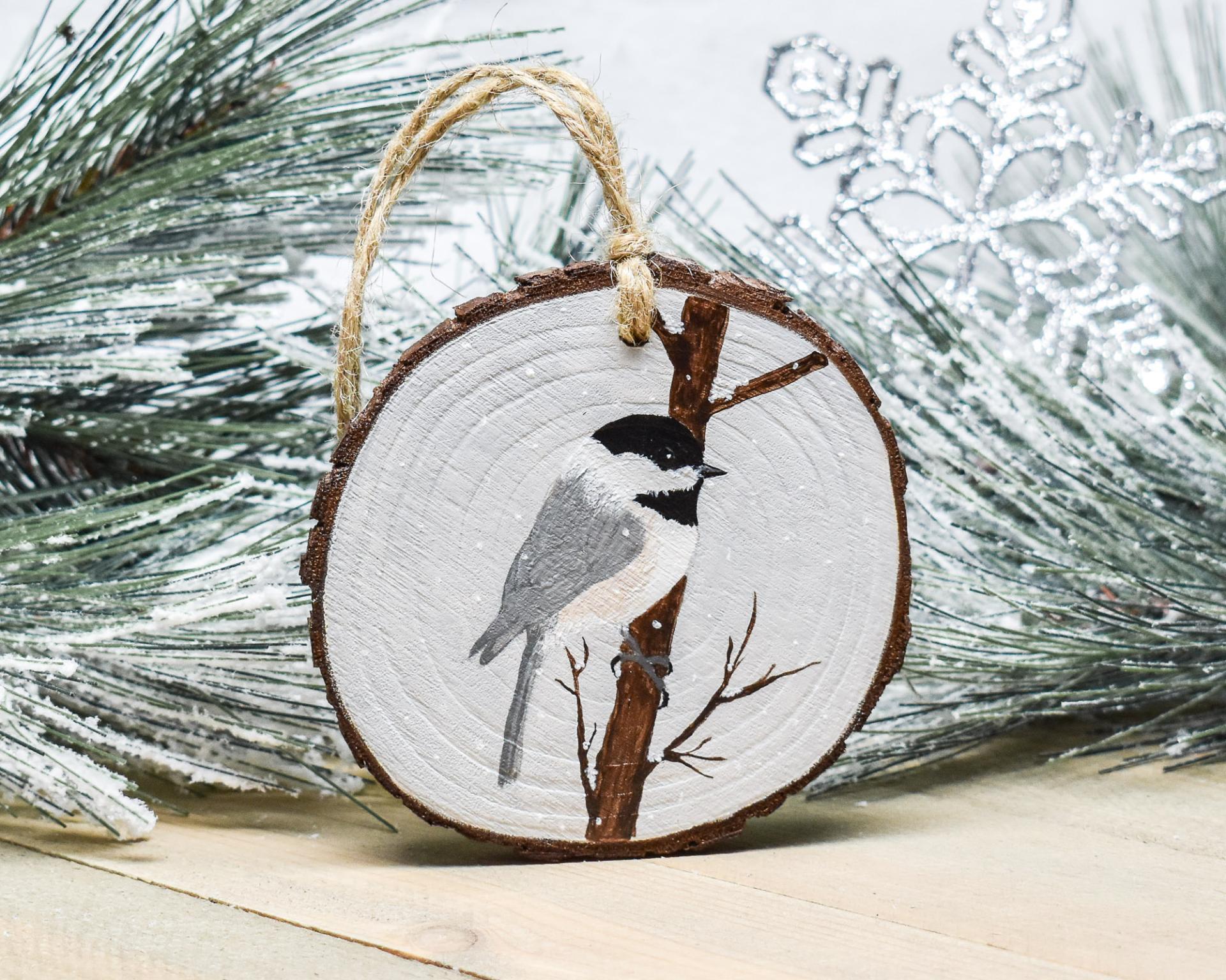 A hand-painted chickadee wood slice ornament available at Cove Creek Photography.