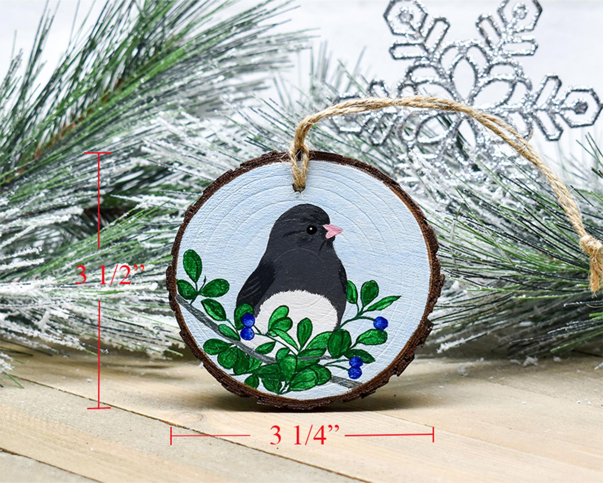 A hand-painted dark-eyed junco Christmas ornament with wood slice measurements at Cove Creek Photography.