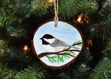 A hand-painted Carolina chickadee on a wood slice available at Cove Creek Photography.