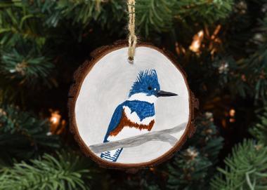 A hand-painted belted kingfisher on a 3 inch diameter wood slice available for purchase at Cove Creek Photography.