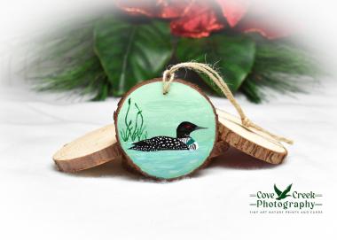 A hand-painted common loon wood slice ornament available at Cove Creek Photography.